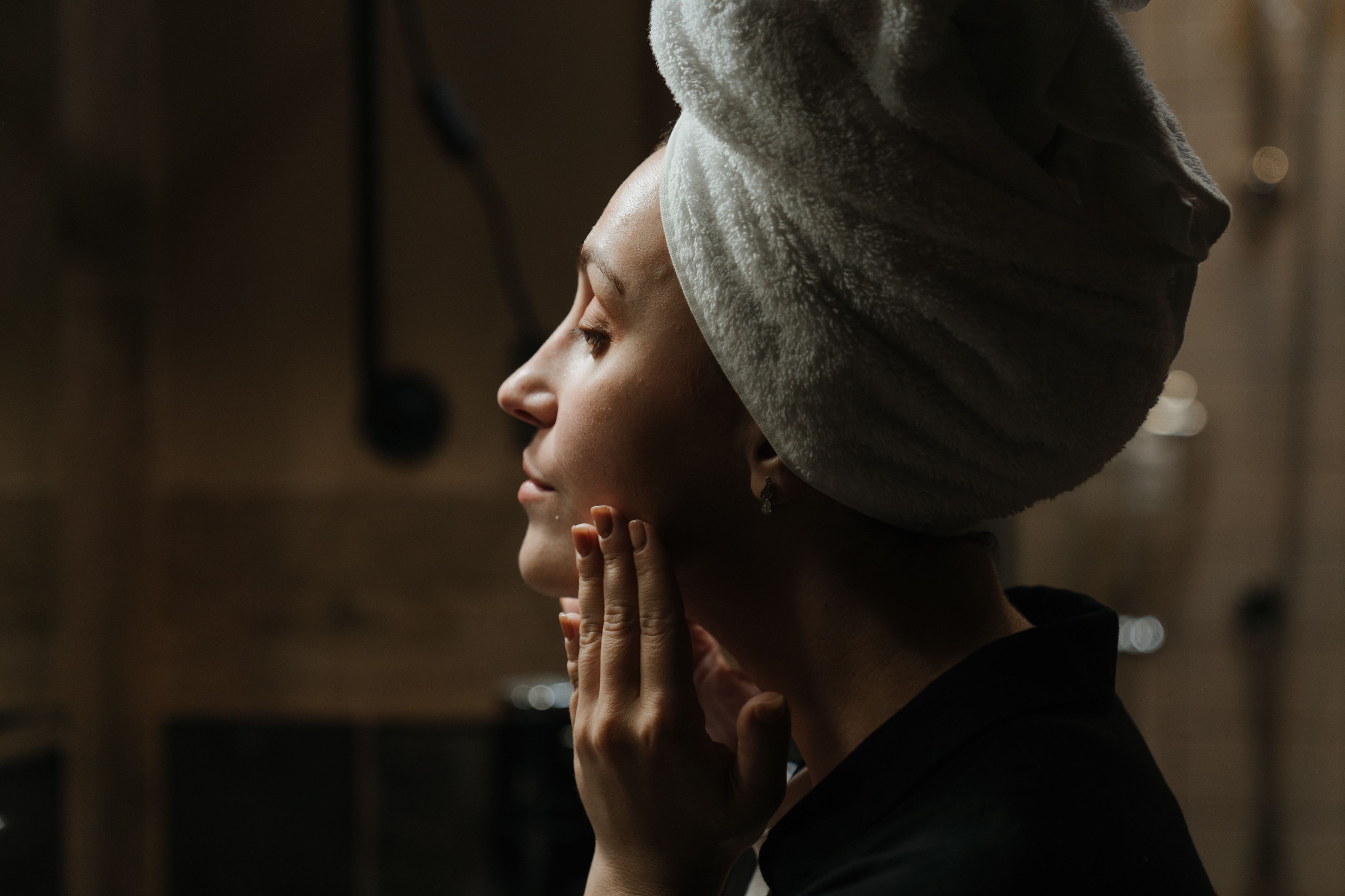 Person applying skincare after a shower